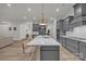 Open kitchen with island seating flows into dining and living areas, creating a connected living space at 513 Meadow Ridge Dr, Belmont, NC 28012
