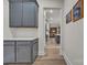 Open-concept kitchen with gray cabinets, quartz countertops, and modern appliances at 513 Meadow Ridge Dr, Belmont, NC 28012
