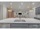 Open concept kitchen with island seating, stainless steel appliances, and view into living room at 513 Meadow Ridge Dr, Belmont, NC 28012