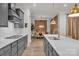 Kitchen island featuring gray cabinets, quartz countertops, with dining room in the background at 513 Meadow Ridge Dr, Belmont, NC 28012
