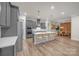 Open concept kitchen with pendant lights, island seating, stainless steel appliances, and dining area at 513 Meadow Ridge Dr, Belmont, NC 28012