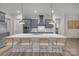 Spacious kitchen features an island with seating, gray cabinets, stainless steel appliances, and pendant lighting at 513 Meadow Ridge Dr, Belmont, NC 28012