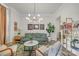 A well-decorated living room with a green couch, patterned rug, pictures on the wall, and natural lighting at 513 Meadow Ridge Dr, Belmont, NC 28012