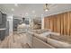 An open-concept kitchen and living room featuring hardwood floors, an island with seating, and recessed lighting at 513 Meadow Ridge Dr, Belmont, NC 28012