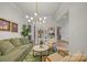 Well decorated living room with a plant, green sofa, hardwood floors, and modern chandelier at 513 Meadow Ridge Dr, Belmont, NC 28012