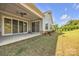 Spacious patio with sliding glass doors and a view of the lush backyard at 513 Meadow Ridge Dr, Belmont, NC 28012