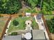 Overhead view of a backyard featuring a manicured lawn, garden, storage shed, and outdoor living spaces at 5424 Tilley Manor Dr, Matthews, NC 28105