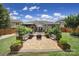 Inviting backyard patio with outdoor seating area, fire pit, and manicured garden beds at 5424 Tilley Manor Dr, Matthews, NC 28105