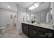 Clean bathroom featuring double sinks, framed mirror, tiled flooring, and shower/tub combo at 5424 Tilley Manor Dr, Matthews, NC 28105