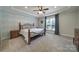 Serene bedroom with tray ceiling, natural light, and neutral tones at 5424 Tilley Manor Dr, Matthews, NC 28105