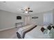 Bedroom featuring neutral walls, plush carpeting, television, and a decorative ceiling fan with light at 5424 Tilley Manor Dr, Matthews, NC 28105