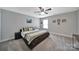 Spacious bedroom featuring neutral walls, plush carpeting, and a decorative ceiling fan with light at 5424 Tilley Manor Dr, Matthews, NC 28105
