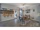 Charming dining area featuring a wooden table, eclectic seating, and unique guitar decor at 5424 Tilley Manor Dr, Matthews, NC 28105