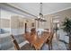 Elegant dining room with decorative lighting, wainscoting, and neutral wall tones at 5424 Tilley Manor Dr, Matthews, NC 28105
