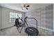 Bright exercise room with exercise equipment, a ceiling fan, and a large window at 5424 Tilley Manor Dr, Matthews, NC 28105