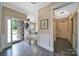 Spacious foyer with hardwood flooring, elegant trim, and a view into the living area at 5424 Tilley Manor Dr, Matthews, NC 28105