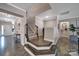 Open foyer showcasing hardwood floors, staircase, and stylish decor at 5424 Tilley Manor Dr, Matthews, NC 28105