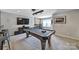 Bright game room featuring a pool table, custom bar area, and mounted flat screen TV at 5424 Tilley Manor Dr, Matthews, NC 28105