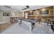 Upstairs game room featuring a pool table, bar area, custom wood accents, and modern lighting at 5424 Tilley Manor Dr, Matthews, NC 28105