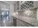 Well-appointed kitchen area showcases wine storage, granite counters, and modern backsplash at 5424 Tilley Manor Dr, Matthews, NC 28105