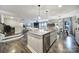 Open concept kitchen with stainless steel appliances, granite counters, an island, and access to the dining area at 5424 Tilley Manor Dr, Matthews, NC 28105