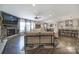 Spacious living room open to the kitchen, featuring a stone fireplace and hardwood floors at 5424 Tilley Manor Dr, Matthews, NC 28105