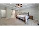 Spacious main bedroom featuring a sliding barn door, decorative wall, and modern ceiling fan at 5424 Tilley Manor Dr, Matthews, NC 28105
