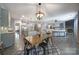 Open concept living space with kitchen island, dining area, and cozy fireplace at 5424 Tilley Manor Dr, Matthews, NC 28105