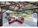 Cozy outdoor patio with comfortable seating, ceiling fan, and views of the landscaped backyard at 5424 Tilley Manor Dr, Matthews, NC 28105