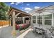Covered patio with outdoor seating, grill area, a ceiling fan, and an umbrella-covered dining table at 5424 Tilley Manor Dr, Matthews, NC 28105
