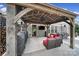 Stylish outdoor patio with a wood-beam pergola, comfortable seating, a grill, and outdoor television for entertaining at 5424 Tilley Manor Dr, Matthews, NC 28105