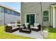 Outdoor patio with wicker furniture set on a patterned rug and string lights for entertaining at 5635 Agora Ct, Lancaster, SC 29720