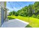 A spacious backyard features a concrete patio, expansive lawn, and string lights, perfect for outdoor entertaining at 5635 Agora Ct, Lancaster, SC 29720