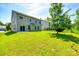 Exterior of the house showing the back yard with a manicured lawn and sliding glass doors to the patio at 5635 Agora Ct, Lancaster, SC 29720