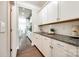 Butler's pantry offers granite countertops, white cabinetry, and convenient access at 5635 Agora Ct, Lancaster, SC 29720