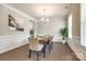 Formal dining room boasts wainscoting, hardwood floors, and a stylish chandelier at 5635 Agora Ct, Lancaster, SC 29720