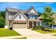 Charming two-story home with stone accents, a covered porch, well-kept landscaping, and a two car garage at 5635 Agora Ct, Lancaster, SC 29720