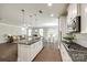 Open concept kitchen with granite countertops, stainless appliances, and an island at 5635 Agora Ct, Lancaster, SC 29720