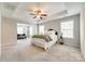 Spacious main bedroom boasts a tray ceiling, ceiling fan, and sitting area with large windows at 5635 Agora Ct, Lancaster, SC 29720
