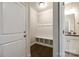 Convenient mudroom featuring hooks, seating, and easy access to a half bathroom at 5635 Agora Ct, Lancaster, SC 29720