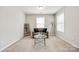 Bright sitting room features a comfortable couch, stylish coffee table, and natural light from two windows at 5635 Agora Ct, Lancaster, SC 29720