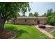 Expansive backyard with mature trees, green grass, and a charming brick home exterior at 5958 Hoover Elmore Rd, Lincolnton, NC 28092