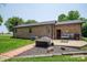 Beautiful backyard with a brick pathway, lush lawn, and a patio with outdoor seating at 5958 Hoover Elmore Rd, Lincolnton, NC 28092