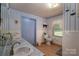 The bathroom features a double vanity, toilet, window, and white tile at 5958 Hoover Elmore Rd, Lincolnton, NC 28092