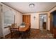 A dining room features a wooden table with chairs, a window, and a carpeted floor at 5958 Hoover Elmore Rd, Lincolnton, NC 28092