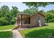 Beautiful brick home with a covered porch and manicured lawn, creating a welcoming outdoor space at 5958 Hoover Elmore Rd, Lincolnton, NC 28092