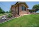 Brick home with covered porch, landscaped yard, and exterior staircases offers charm and accessibility at 5958 Hoover Elmore Rd, Lincolnton, NC 28092