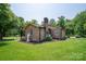 Charming brick home with manicured lawn, mature trees, and inviting curb appeal at 5958 Hoover Elmore Rd, Lincolnton, NC 28092