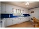 This kitchen has white cabinets, blue countertops, and linoleum flooring at 5958 Hoover Elmore Rd, Lincolnton, NC 28092