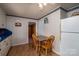An eat-in kitchen area features a table, two chairs, and a refrigerator at 5958 Hoover Elmore Rd, Lincolnton, NC 28092